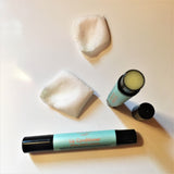 Lip Conditioner with cap off and rose petals.